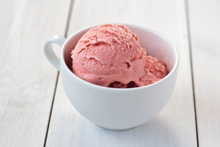 strawberry ice cream in a white cup
